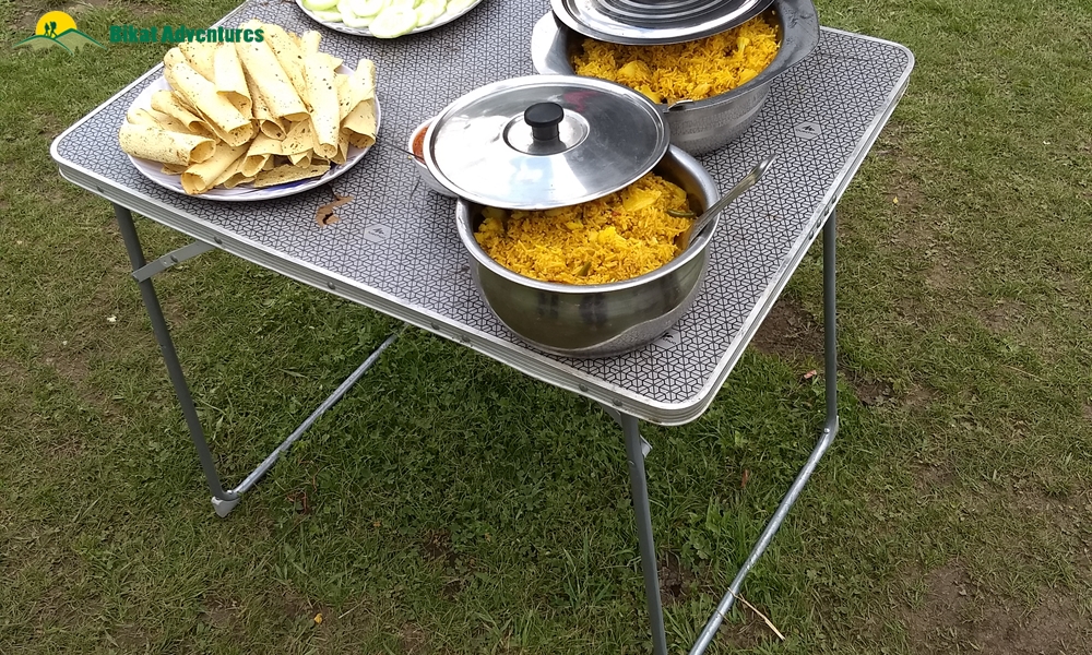 Group having hot soup at campsite