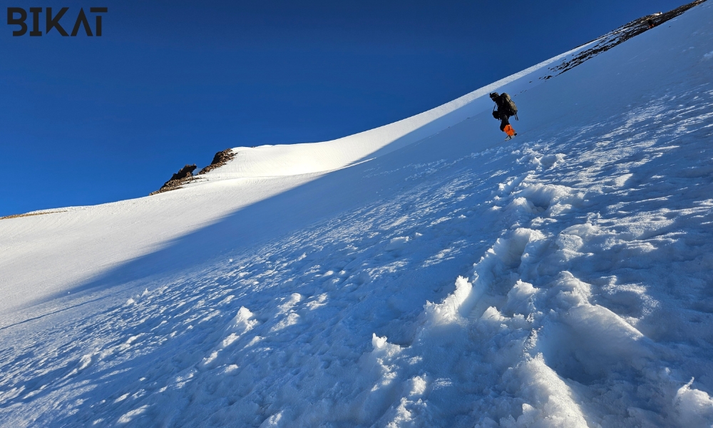 Climbers on summit day at Yunam Peak with snow-covered terrain